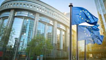 European union flag against parliament in Brussels