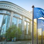 European union flag against parliament in Brussels, Belgium